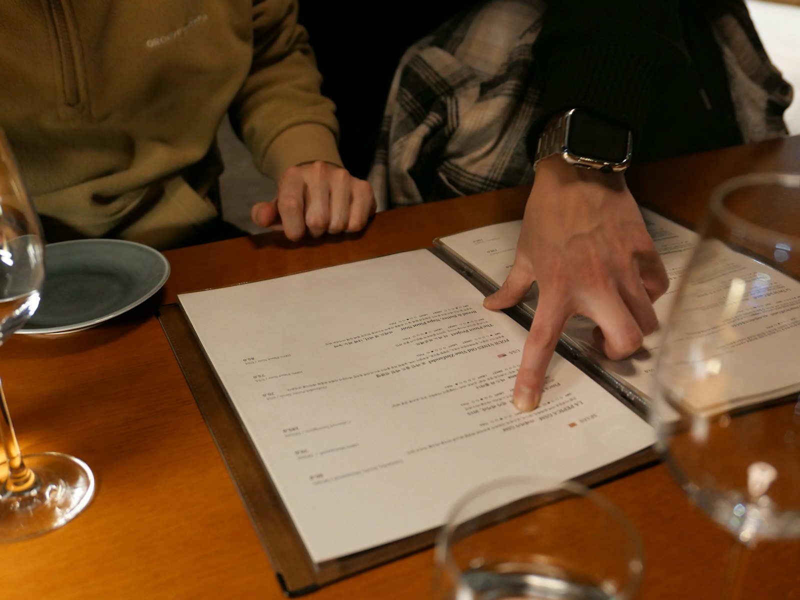Two guests reviewing a printed menu